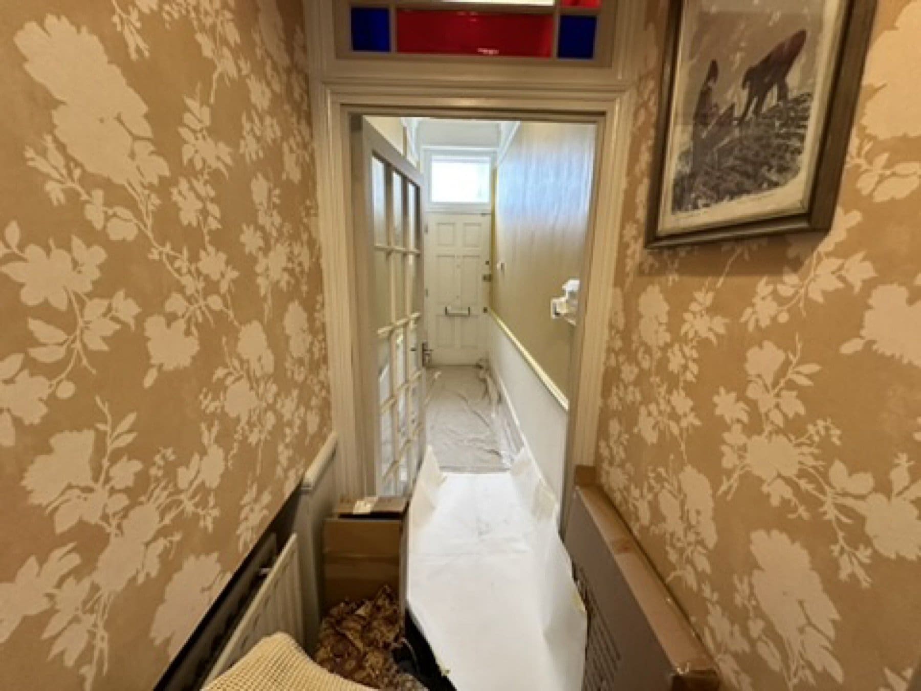 Floral wallpaper and upholstered seating in the Penny Morrison showroom.