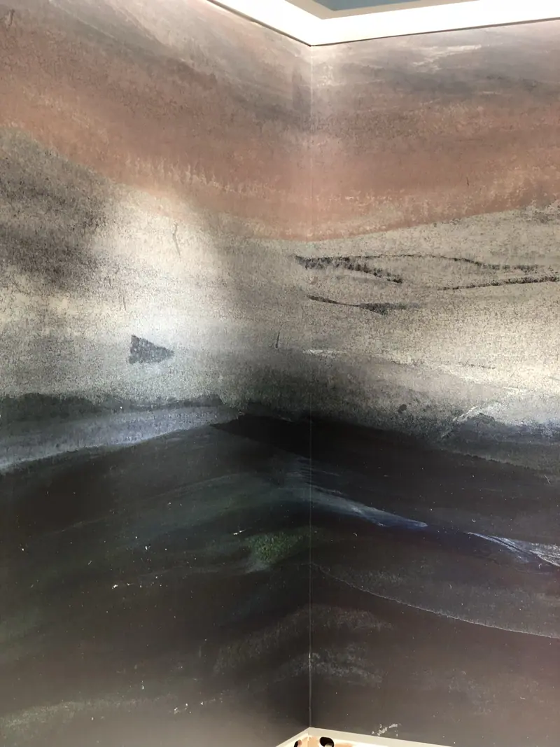 The mural wrapped around an internal corner, full height.
