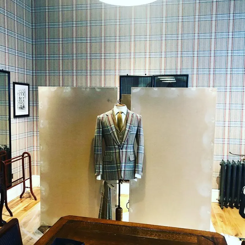 Display board in Huntsman tweed print with a suit on a stand.