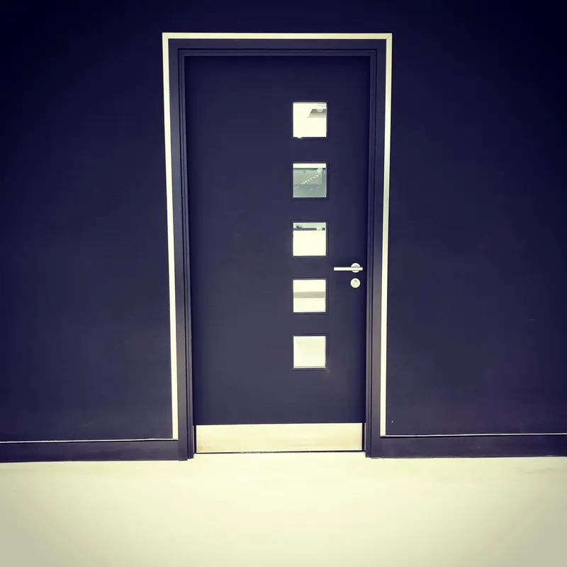 Black matt Muraspec walls around a door with a brushed stainless-steel trim, Mercedes-AMG showroom, London.