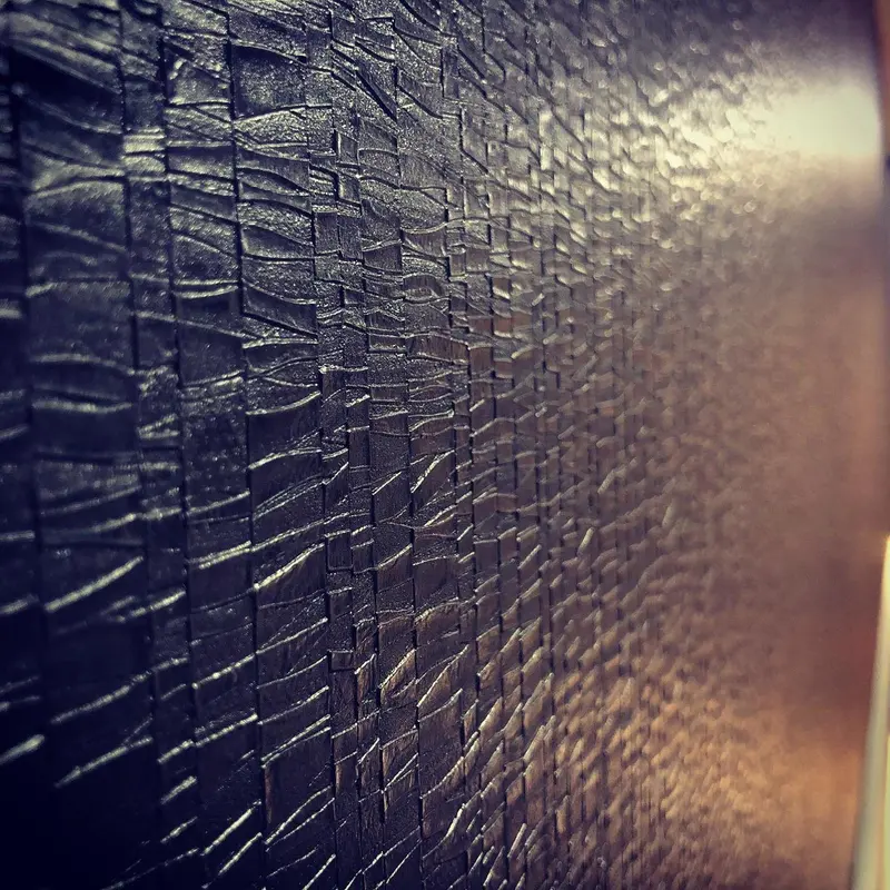 Close-up of a jet-black textured Muraspec wallcovering, Hilton London Metropole.