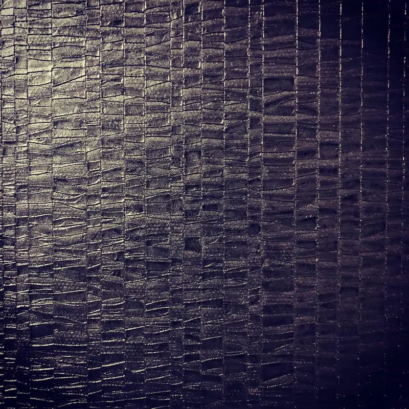 Detail of a jet-black embossed Muraspec wallcovering, Hilton London Metropole.