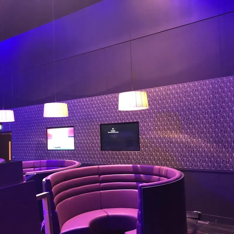 Oxygen Freejumping at The O2: purple-lit seating area with bespoke digital wallcoverings.