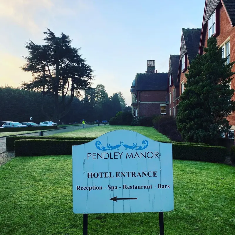 Pendley Manor entrance sign in front of the Victorian manor house.