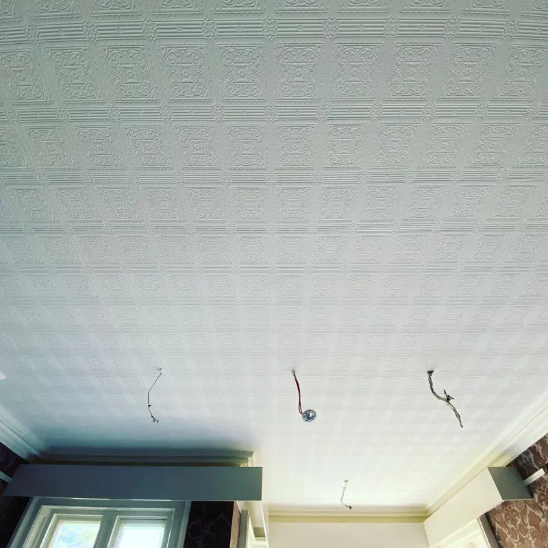 Freshly papered Anaglypta ceiling in a Pendley Manor room.