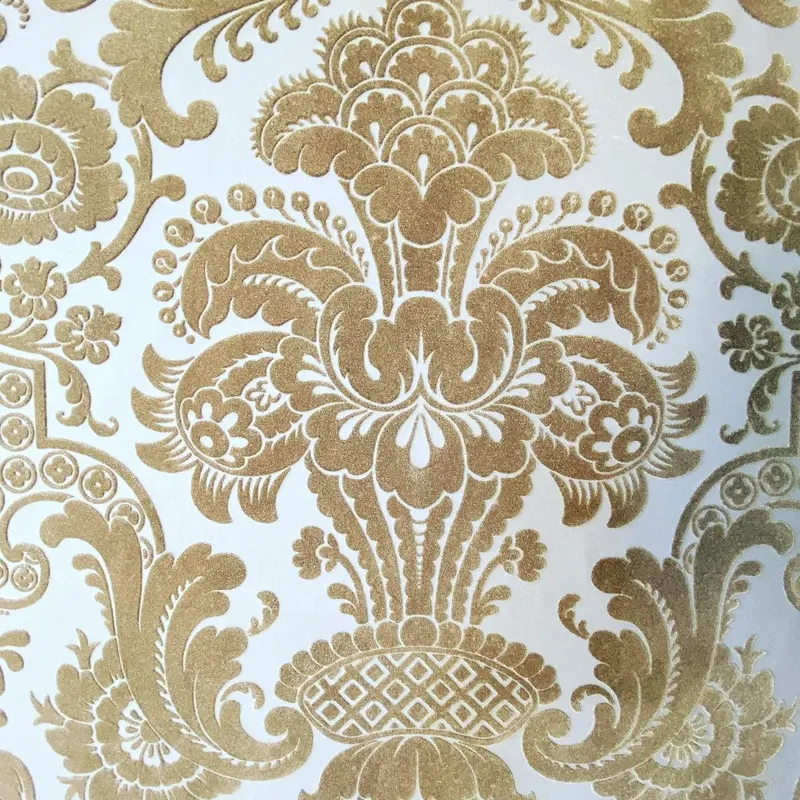 Close-up of gold-on-cream Petroushka velvet flock wallpaper, Pendley Manor Hotel, Tring.