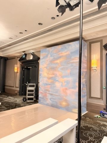 The Estuary mural by Ahluwalia for Calico Wallpaper installed as the runway backdrop at Rosewood London.