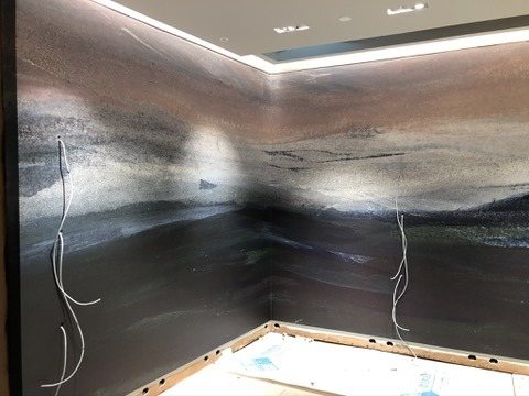 The Calico Wallpaper landscape mural running unbroken around a corner of the Terminal 4 store.