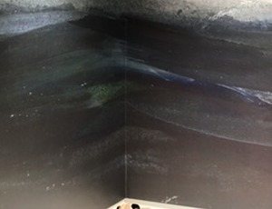 Detail of the dark ground of the mural wrapping the corner.