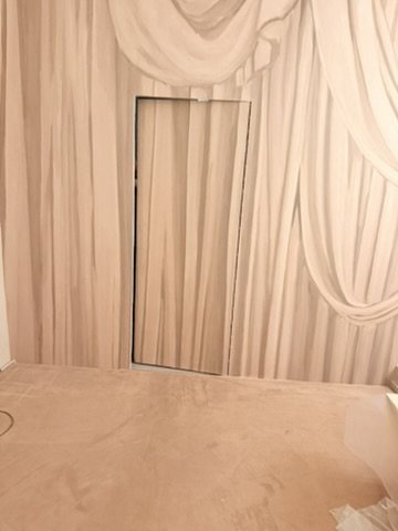 Calico Wallpaper Overture trompe-l'oeil curtain carried across a concealed door at Lee Broom's Shoreditch showroom.