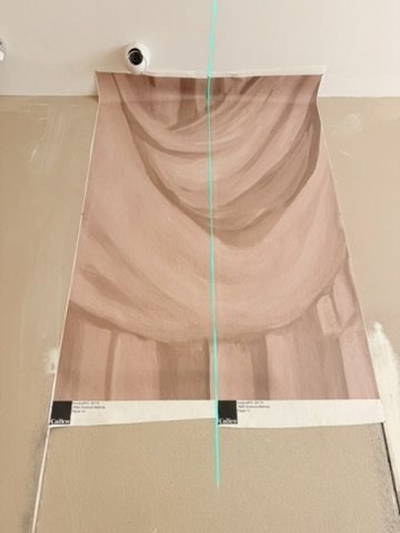 Setting out an Overture panel against a plumb line.