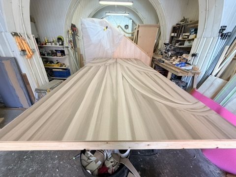 A theatrical flat papered in Overture on the workshop bench.