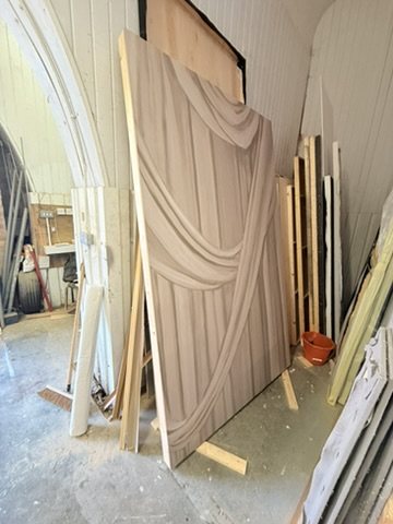 A papered Overture flat standing in the set builder's workshop.