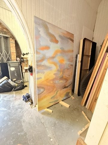 A freestanding panel finished in Calico Wallpaper's Estuary in the set builder's workshop.