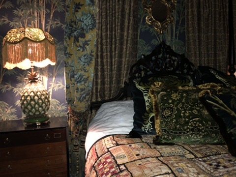 Bedside detail with lamp and Bambusa wallpaper.