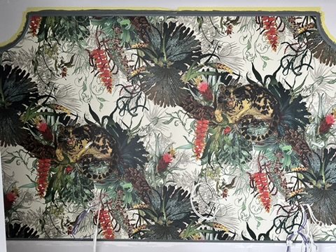 Timorous Beasties Tropical Clouded Leopard wallpaper hung as a headboard panel.