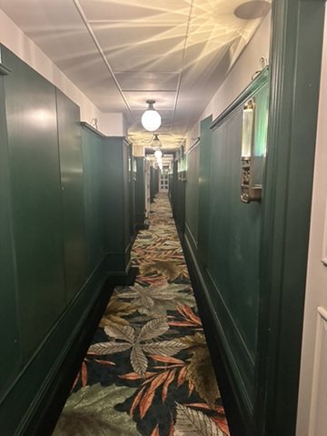 Green-painted guest corridor at Hyde London City.