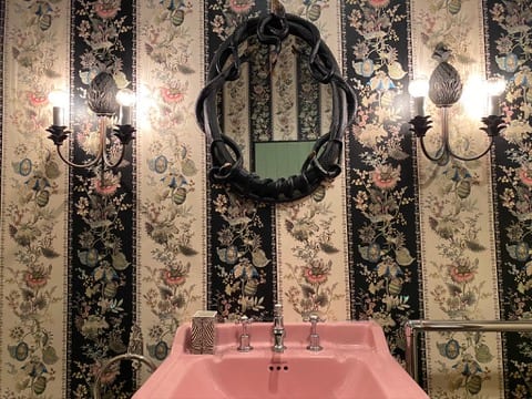 Powder room at the Castle of Trematon papered in a floral stripe.