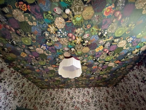 Small box room at the Castle of Trematon papered on the walls and ceiling.