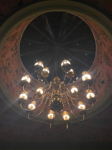 Papered atrium ceiling with a chandelier at the Castle of Trematon.